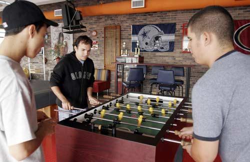 IT'S A GAME: Costa Rican employees of BoDog Sportsbook take a break in the company's recreation room in San Jose, Costa Rica, Friday.