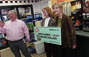 Linda Hunt, right, of Covington, poses with her sister Connie Habeck of Gray after Connie was formally presented with her $5 million Georgia Lottery winnings by lottery district manager Wayne Watson in the Conoco store on Gray Highway in Macon where she bought the ticket. 
