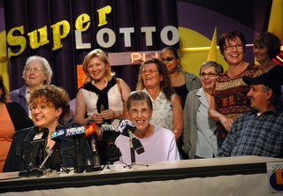 Gloria Madriz, left, speaks Tuesday in Sacramento for the group of 20 current and former state employees who won the SuperLotto Plus jackpot drawing on Saturday. The group has been playing the same numbers weekly for 10 years. Some of the winners said they are planning to go on vacations and pay off their mortgages.