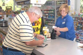 Bob Kilgore, left, of Jasper, Tenn., buys Georgia Lottery tickets from Nickie Davis at the Mapco Fast Food and Fuel market in Wildwood, Ga.