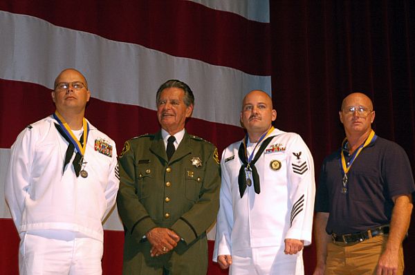 Lottery Post member Verlon Cox, pictured third from the left. The three heros, who saved a woman and her two children are: USS Freedom (LCS 1) Sailors, Mineman 1st Class Ralph Bishop, left, and Electronics Technician 1st Class Verlon Cox and civilian Clarence Good. Each received the Distinguished Service Award, the highest-level civilian decoration.