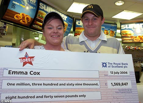 Luke with his wife Emma and their check for over £1.3 million.
