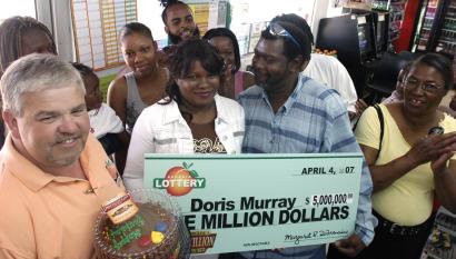 Georgia Lottery District Manager Wayne Watson presented Doris Murray of East Dublin (center left) with her $5 million winnings in 2007.