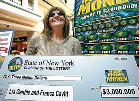Franca Cavitt of Crescent, Pa., is all smiles Monday as she accepts a symbolic 'check' for $3 million won in the New York Lottery by her sister, Lia Gentile of Buffalo.