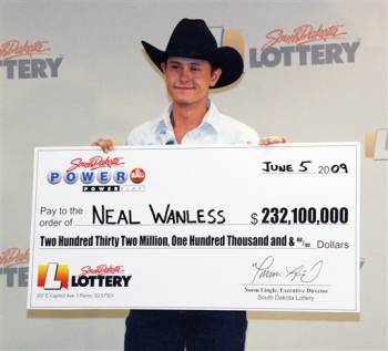 Neal Wanless, 23, accepts a ceremonial check for winning a $232 million Powerball lottery jackpot, Friday, June 5, 2009, in Pierre, S.D. Neal Wanless, who lives on his family's 320-acre ranch near Mission, S.D., bought the winning ticket in the nearby town of Winner late last month during a trip to buy livestock feed.
